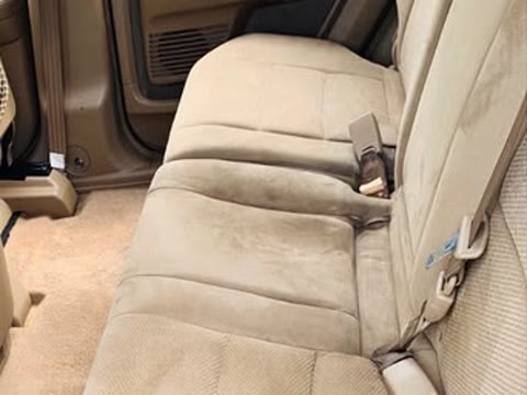 The same seat after an interior detail, fabric back to clean tan