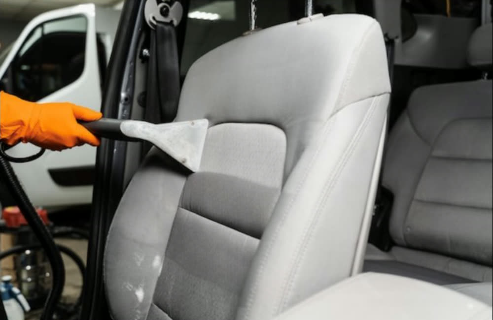 Hot water extraction on a car seat during an interior reset
